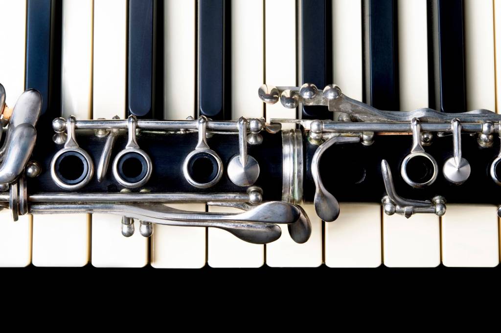 Closeup of a clarinet and keyboard.